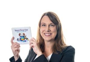 Darbi Hunt holding the children's book "Baby's Busy Day"