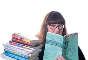 Julie king holding a stack of books on family engagement