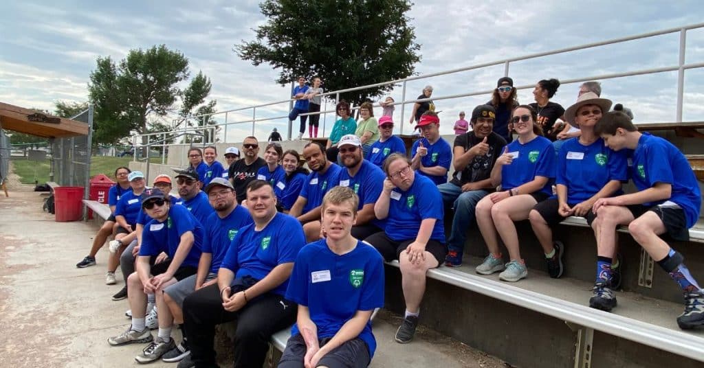 BHSSC Special Olympics Softball Team group photo seated on the bleachers