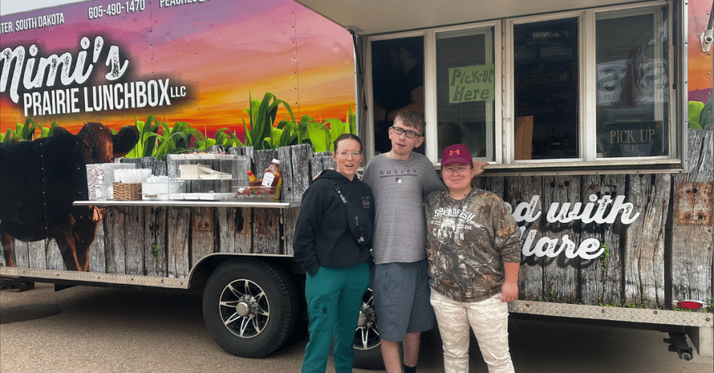 Mimi's Prairie Lunchbox Food Truck parked with three people standing together in front of it