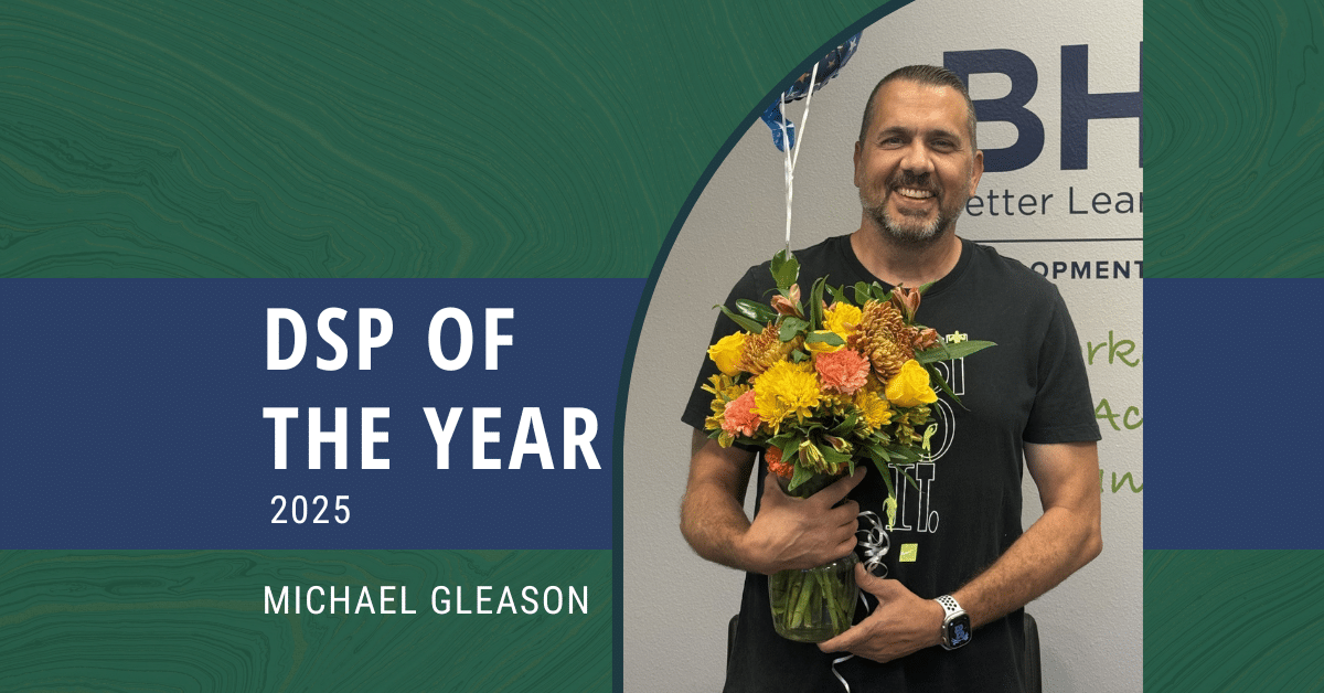 A man holding a balloon and flower bouquet and the text: DSP of the Year 2025, Michael Gleason