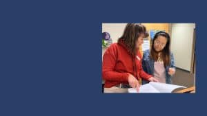 two women looking at a book